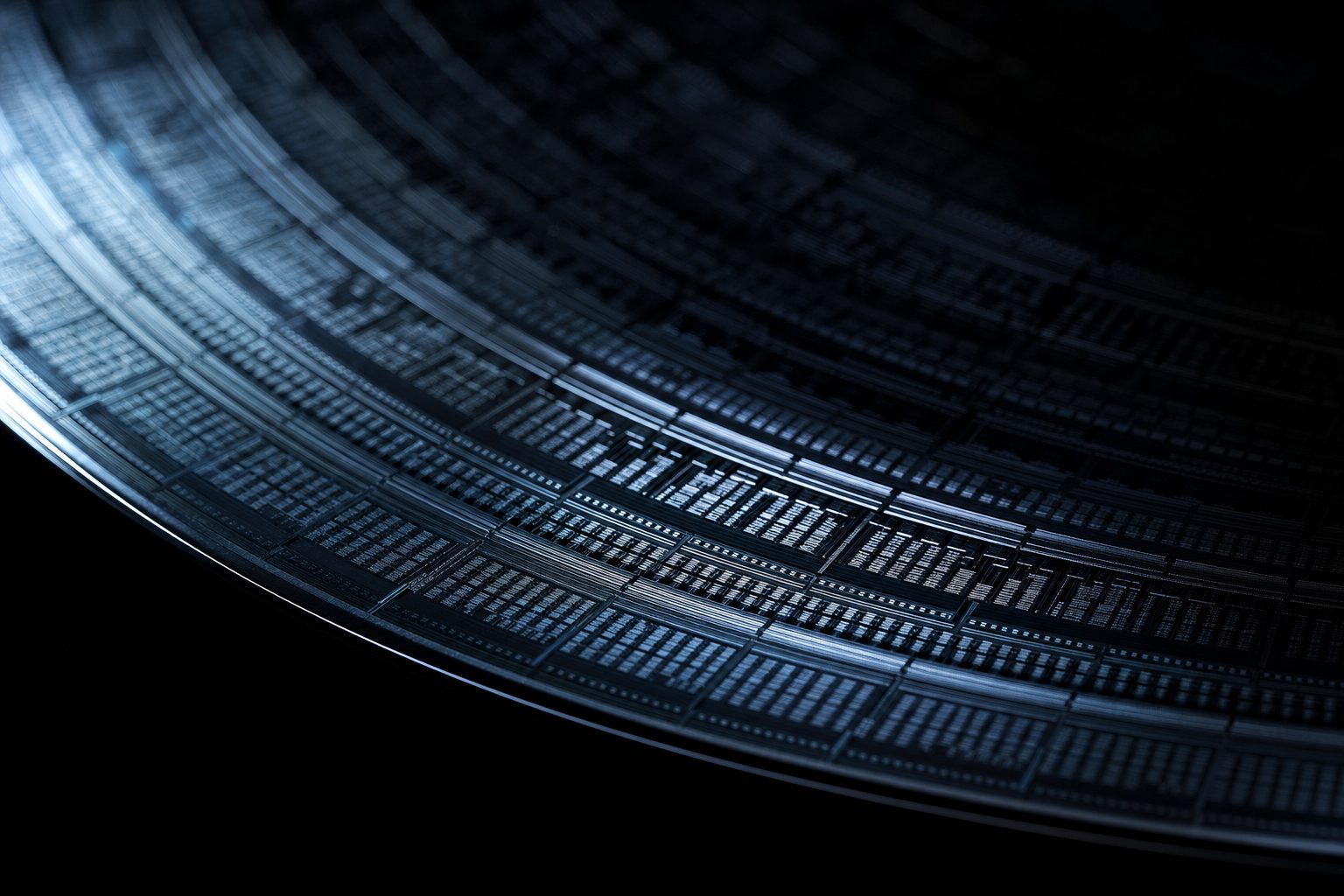 Macro detail of a silicon wafer catching cold blue light